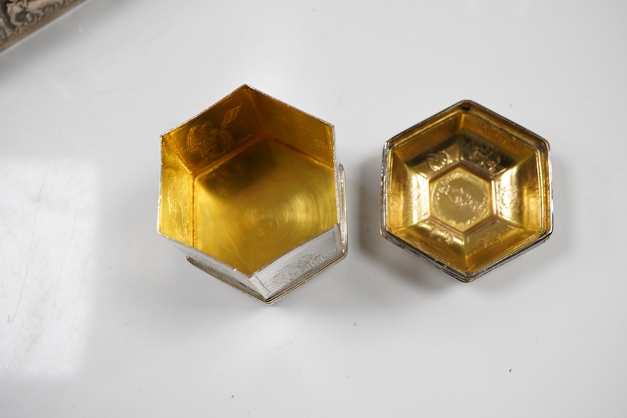 An Edwardian silver vesta case, Birmingham, 1902, 42mm, together with a small Indian white metal box, a pair of white metal Soviet? candlesticks, a plated purse, a plated belt, a hexagonal box and cover stamped MMA and a